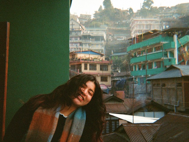 A portrait overlooking a colorful hillside neighborhood