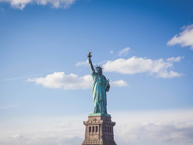 The Statue of Liberty beneath a blue summer sky