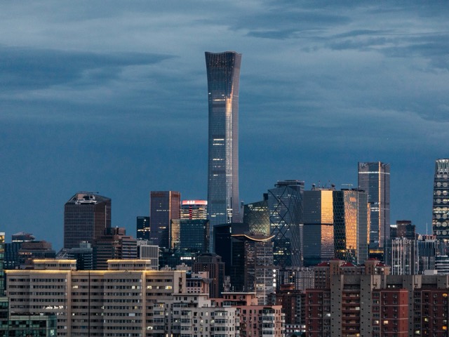 Beijing skyline beneath a moody blue evening sky