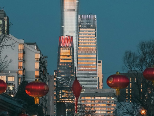 Red lanterns and modern towers sharing a Beijing street view